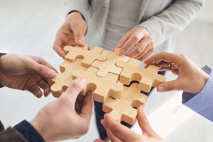 Puzzle pieces connected with team